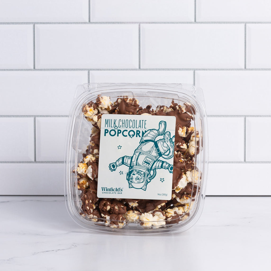 Small clear tub of Winfield's Milk Chocolate Popcorn