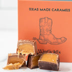 Winfield's Texas-Made Caramels cut open to show golden caramel centres, in front of the orange gift box