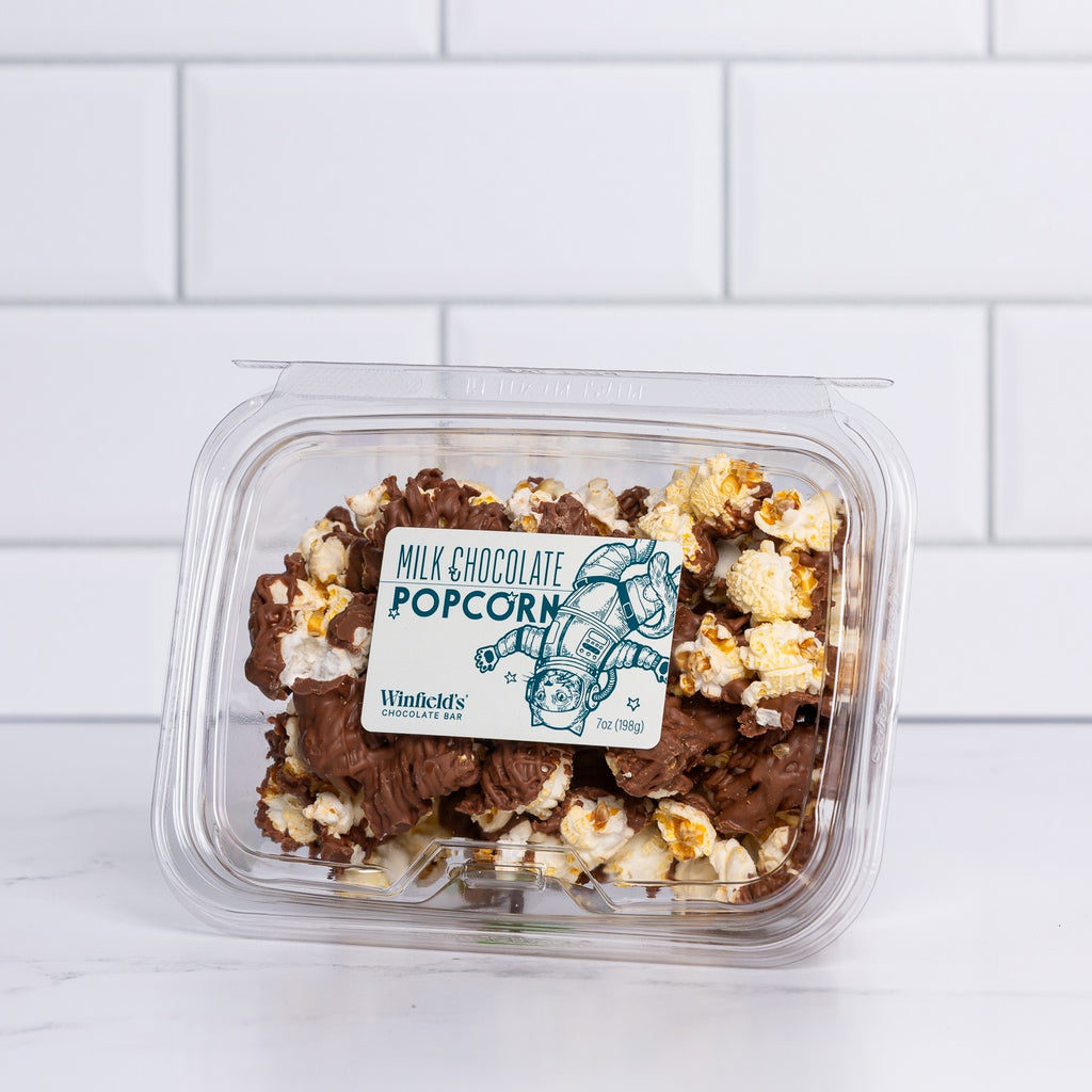 Wide clear tub of Winfield's Milk Chocolate Popcorn