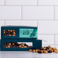 Winfield's Chocolate Blend Coffee Beans in stacked teal window boxes with loose beans alongside