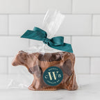Winfield's molded chocolate cow bagged in cellophane with a teal ribbon and the Winfield's seal