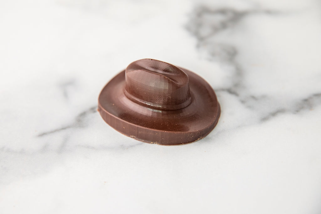 Winfield's molded milk chocolate cowboy hat on a marble surface