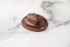 Winfield's molded milk chocolate cowboy hat on a marble surface