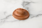 Winfield's molded milk chocolate cowboy hat photographed from a low angle on marble