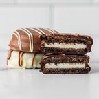 Winfield's chocolate-covered Oreos stacked, one cut open to show the cookie inside