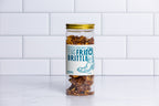 Tall glass jar with a gold lid filled with Winfield's Texas Frito Brittle