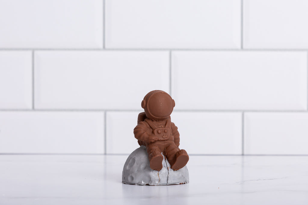 Winfield's molded chocolate astronaut seated on a moon-rock base