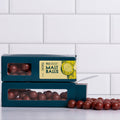 Winfield's Milk Chocolate Malt Balls in stacked teal window boxes with loose malt balls alongside
