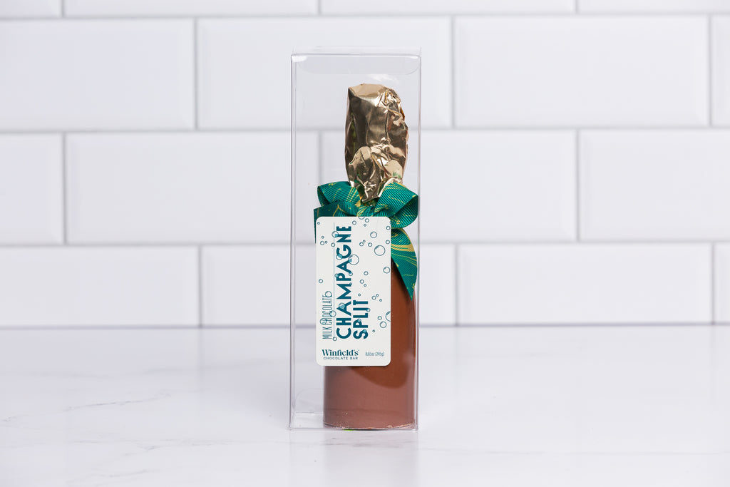 Winfield's milk chocolate champagne split in a clear box with a gold foil neck and green bow