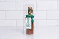 Winfield's milk chocolate champagne split in a clear box with a gold foil neck and green bow