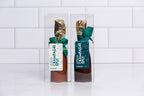 Two Winfield's chocolate champagne splits in milk and dark chocolate, boxed with gold foil necks and green ribbons