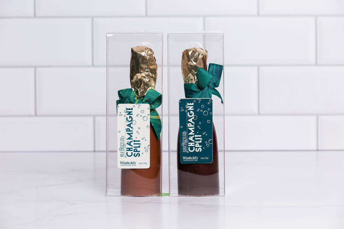 Two Winfield's chocolate champagne splits in milk and dark chocolate, boxed with gold foil necks and green ribbons