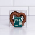 Winfield's Pretzel Twists 2-count box in milk and dark chocolate, shown through the clear window