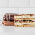 Winfield's chocolate s'mores stacked, one cut open to show the marshmallow and graham layers