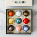Winfield's Space City Truffle Collection 9-piece box viewed from above, lid alongside