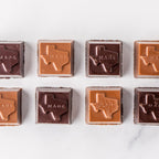Eight Winfield's Texas-Made Caramels in milk and dark chocolate, each embossed with the outline of Texas