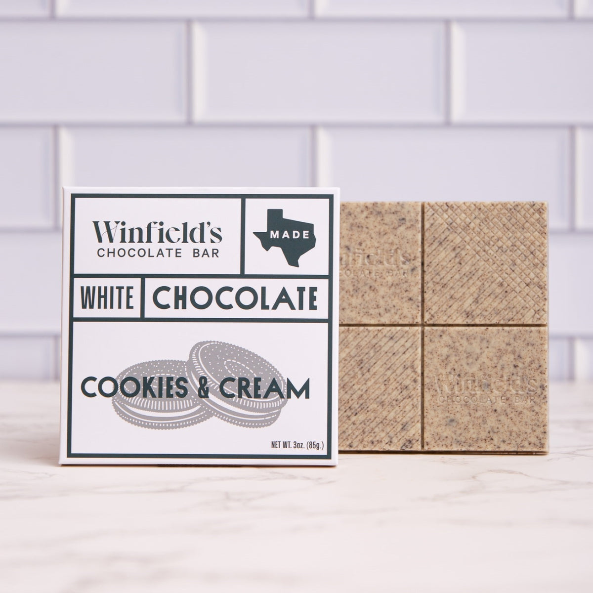 Winfield's White Chocolate Cookies & Cream bar in its wrapper beside the unwrapped bar