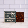 Winfield's Dark Chocolate with Almonds bar in its dark green wrapper beside the unwrapped almond-studded bar