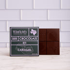 Winfield's Dark Chocolate with Caramel bar in its dark wrapper beside the unwrapped bar