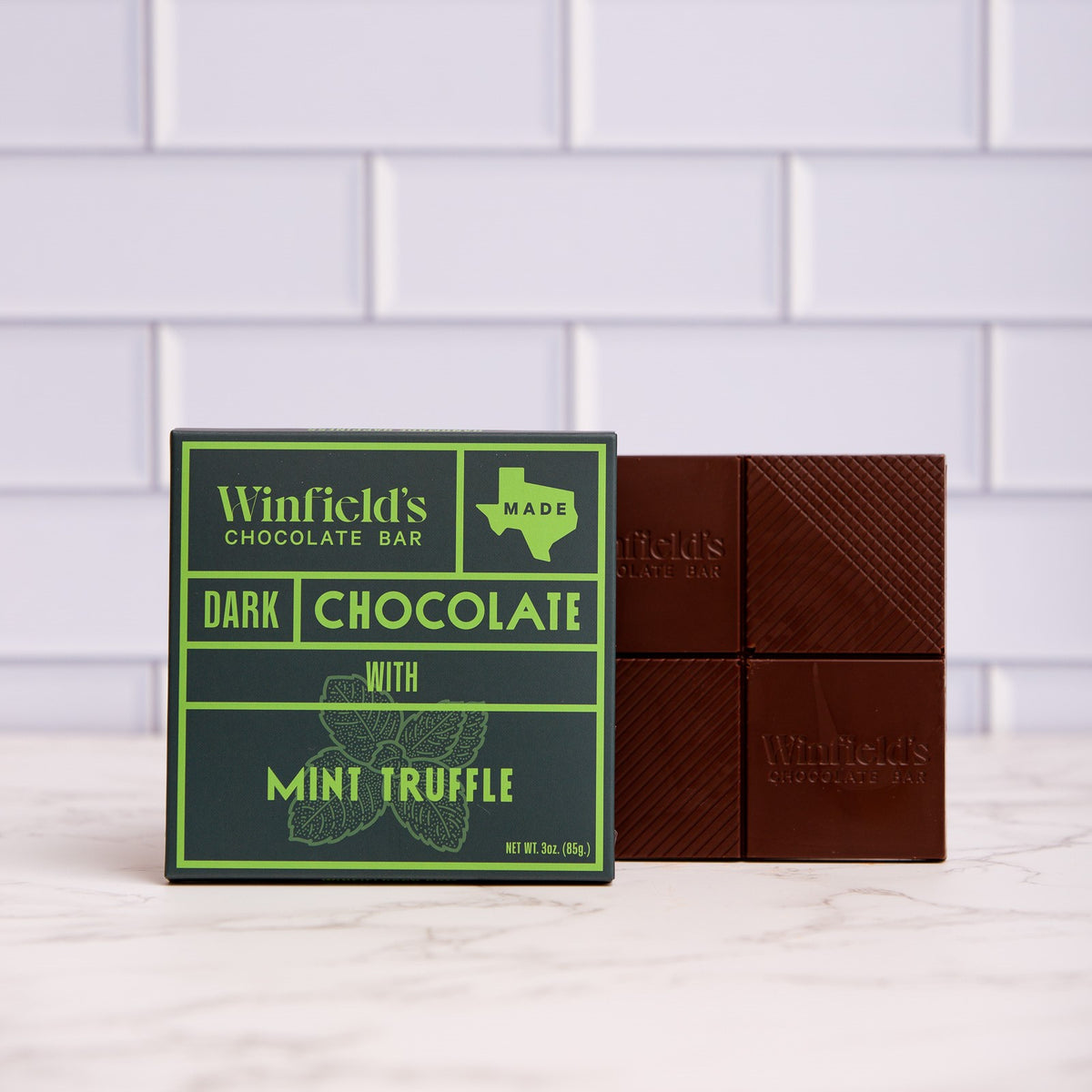 Winfield's Dark Chocolate Mint Truffle bar in its green wrapper beside the unwrapped bar