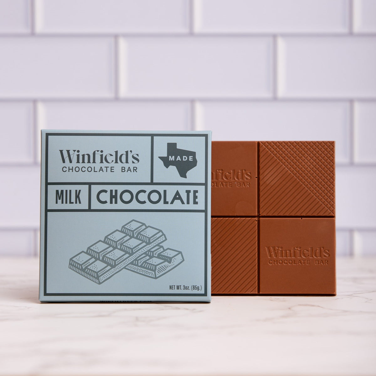 Winfield's solid Milk Chocolate bar in its pale blue wrapper beside the unwrapped bar