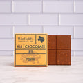 Winfield's Milk Chocolate with Toffee bar in its yellow wrapper beside the unwrapped bar