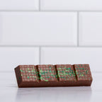 Unwrapped Winfield's Milk Chocolate Dubai Bar showing the green pistachio and kataifi filling