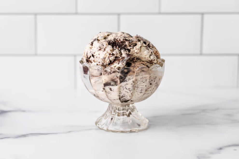 A scoop of Winfield's cookies-and-cream ice cream in a footed glass dish