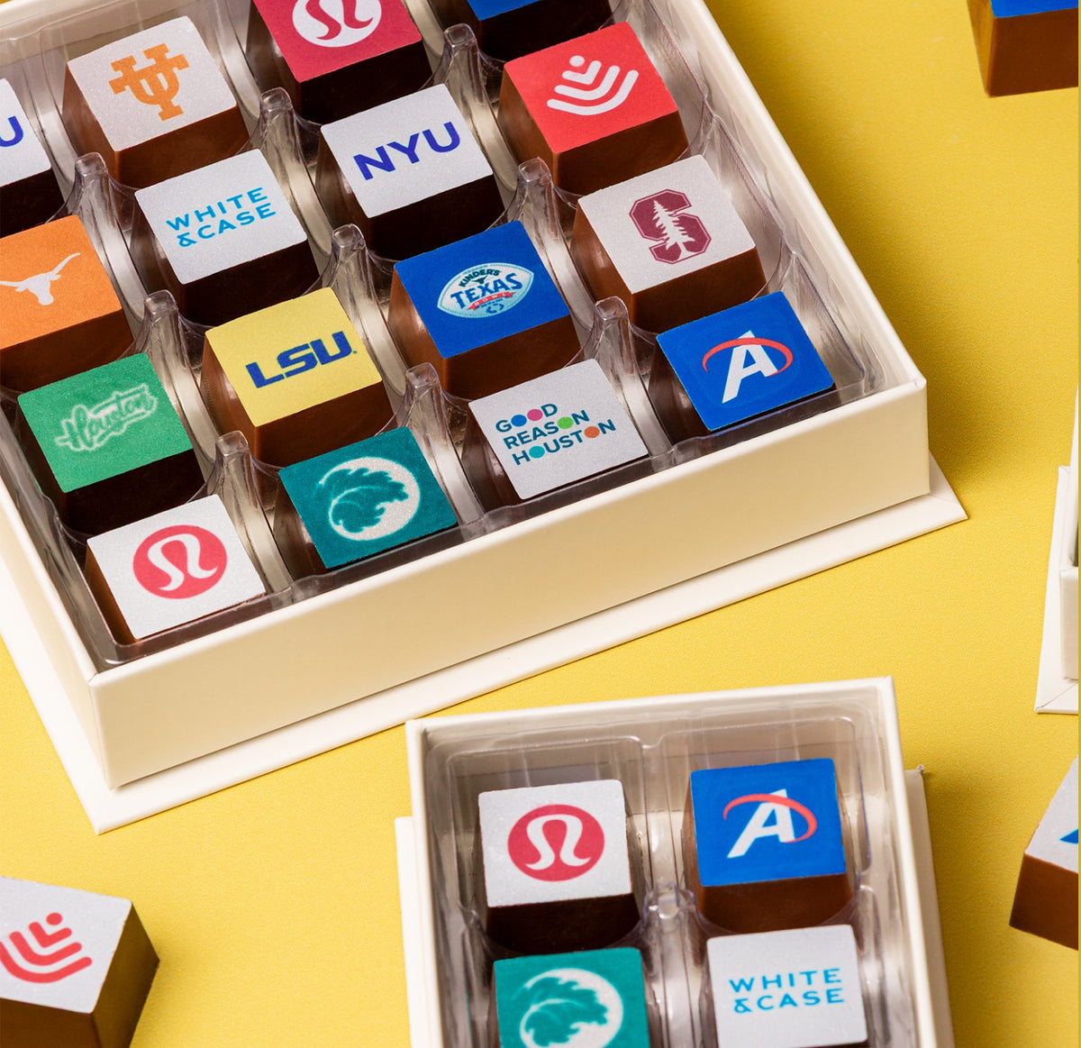 Boxes of custom logo chocolates on a yellow background