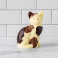 Winfield's molded white chocolate cat with dark chocolate patches, seated