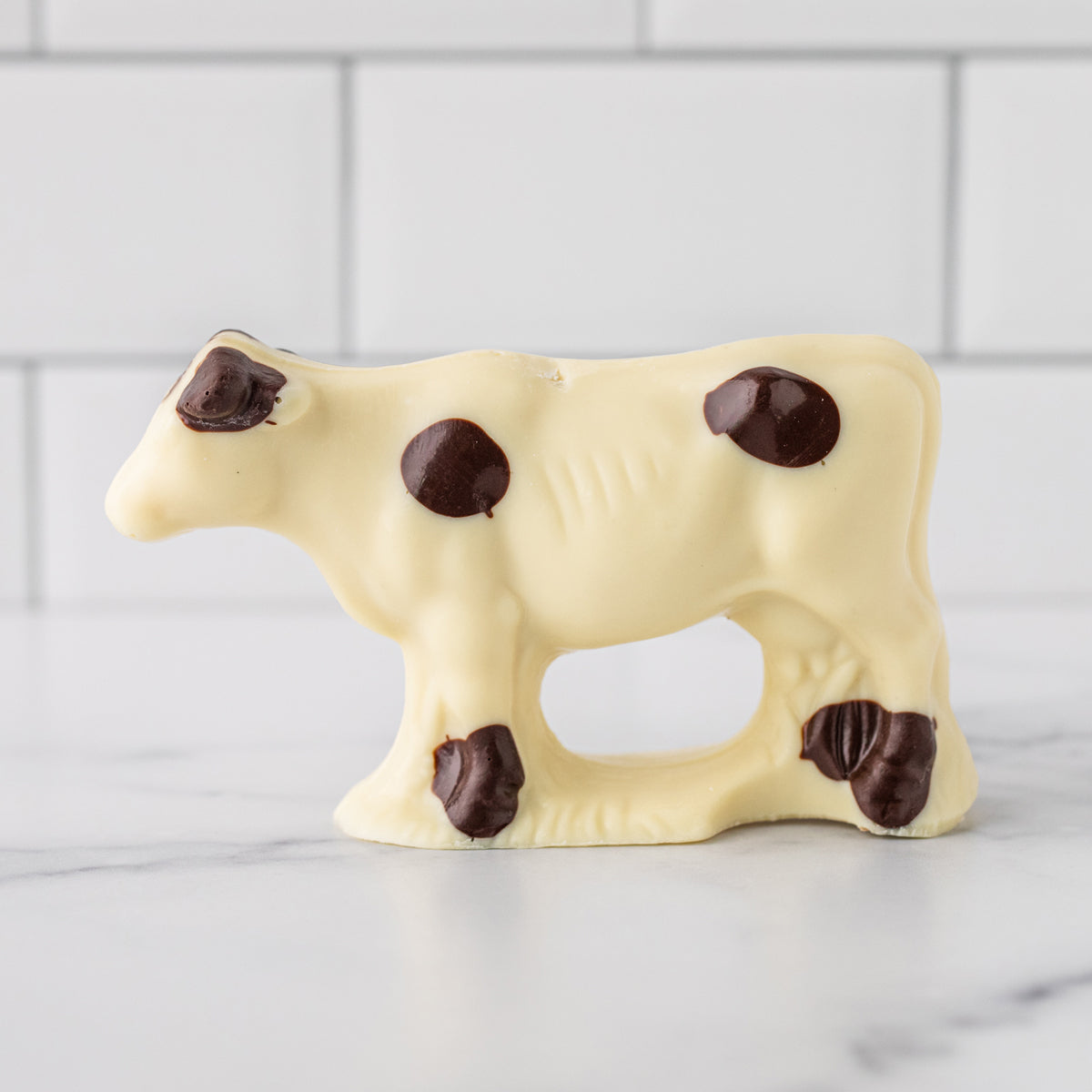 Winfield's white chocolate cow with dark chocolate markings, side view